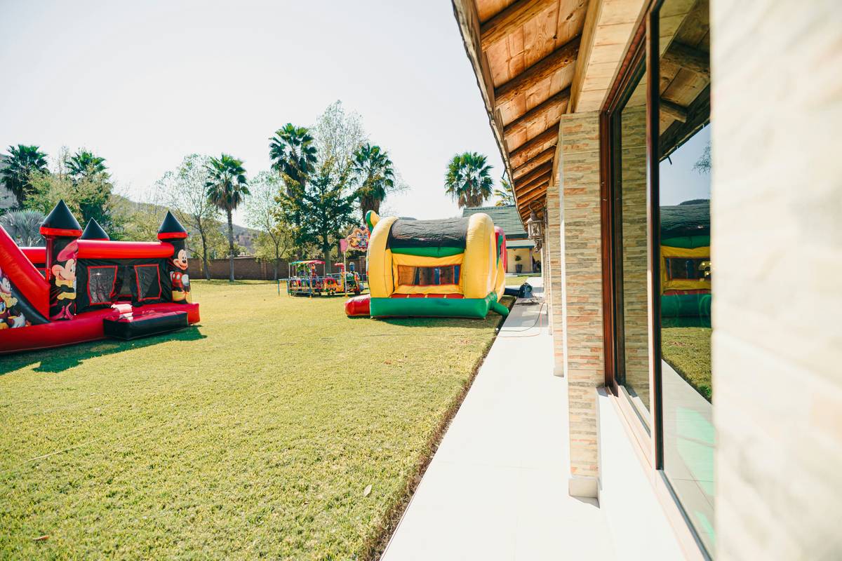 Historic jump castle rental setup next to a real castle tower with children playing