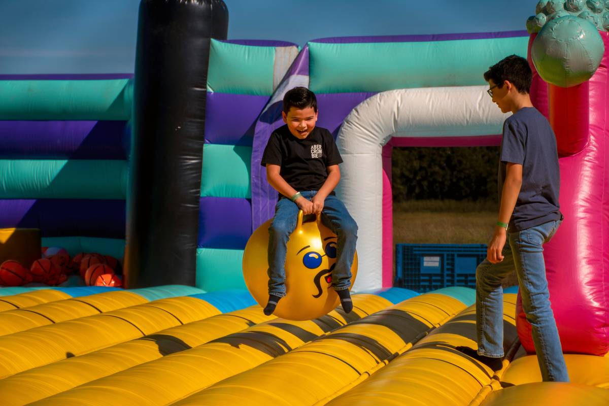Inflatable castle rental set up in a suburban backyard with children playing nearby